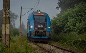 Mist morning with electric trains in Rajcza town with Sola river in middle of summer