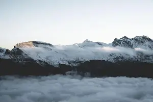 Mist at sunrise covering Faulhorn mountain peak in the clouds, Mannlichen, Jungfrau Region, Bern canton, Switzerland