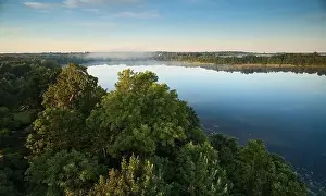 Misty lake in sunrise time with fog aerial drone view