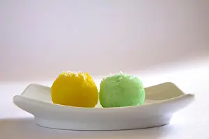 Eatable Prints: Mithai ; colourful nariyal ka laddoos in rectangle plate on white background