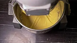 Prepare Prints: Mixing dough for bread baking with professional kneader spiral machine at the manufacturing