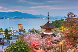 Miyajima Island, Hiroshima, Japan with temples on the Seto Inland Sea at dusk in the spring season
