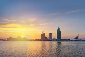 Mobile, Alabama, USA downtown skyline on the river at sunset