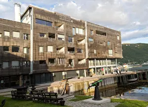 Arctic Circle Prints: Modern architecture wooden apartment building on waterside in city centre, Tromso, Norway