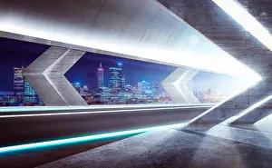 Trace Prints: Modern asphalt road in glass tunnel with beautiful city skyline background. Night scene