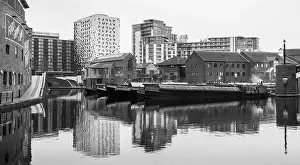 Waters Edge Prints: Modern buildings and canal boats reflect in the water of the Birmingham Canal old line which runs into the city centre
