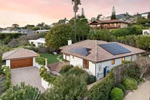 Functional Prints: A modern home with a raised courtyard and solar panel-covered roof