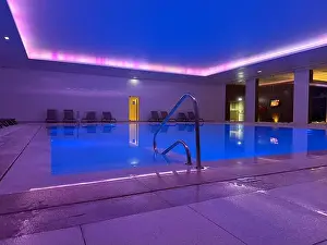 Water Blue Prints: modern indoor swimming pool with blue water and purple ambient lighting concept of vocation