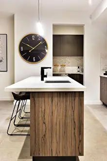 Faucet Prints: Modern kitchen countertop made in wood with a wall watch and chairs of a luxury house