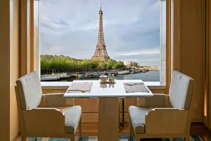 Modern luxury restaurant interior with romantic sence Eiffel Tower and Seine river view in Paris, France. Dinning table in restaurant at Paris, France