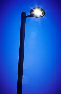 Floodlight Prints: Modern street lamp by night. Vertical format