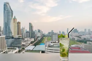 Mojito cocktail on table in rooftop bar with Bangkok city view point in Bangkok Thailand. Beautiful rooftop bar in Bangkok
