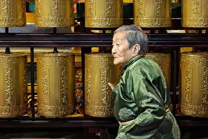 Contemplative Prints: Mongolian woman, dressed in a traditional green silk Deel