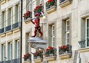 Bern Prints: Monkey statue on one of the buildings in Kramgasse street with shopping area in old city center of Bern