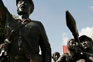 Communist Prints: Detail of a monument celebrating the communist victory over the US and reactionary Laotian forces in 1975
