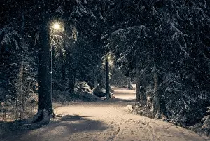 Curvy Road Prints: Moody landscape with snow path and light at winter evening in Finland