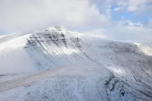 Beacons Prints: Morning light hits the north face of snow covered Pen Y Fan in the Brecon Beacons, Wales