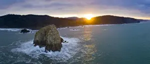 Morning light illuminates rocky sea stacks just off the coast of Northern California in Klamath. The Pacific Coast Highway runs along this shoreline