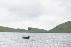 Images Dated 7th August 2019: Morning view on lonely boat on cloudy Sorvagsvatn lake on cliffs of Vagar island, Faroe Islands