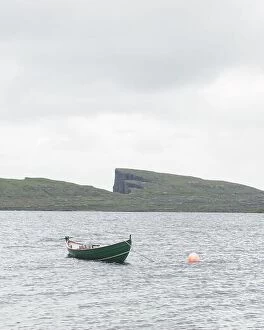 Images Dated 7th August 2019: Morning view on lonely boat on cloudy Sorvagsvatn lake on cliffs of Vagar island, Faroe Islands