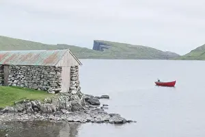 Morning view on lonely boat on cloudy Sorvagsvatn lake on cliffs of Vagar island, Faroe Islands, Denmark. Landscape photography