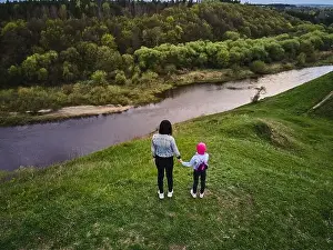Mother and daughter enjoys the view on the coast Sluch river hills, Gubkiv village Travel destinations in Ukraine