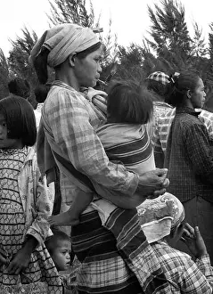 Philippine Prints: Mother holding child while smoking a cheroot pipe in crowd of people waiting for a bus 1959 People Street Scene