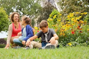 Mars Prints: Mother, son and daughter sitting on the grass in the park in Paris