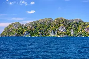 Krabi Prints: Motor ship in the bay of Ko Phi Phi Don Island with huge rocks and cliffs on a sunny day