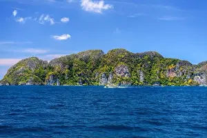 Krabi Prints: Motor ship in the bay of Ko Phi Phi Don Island with huge rocks and cliffs on a sunny day