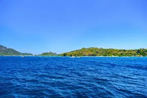Krabi Prints: Motor ship in the bay of Ko Phi Phi Don Island with huge rocks and cliffs on a sunny day