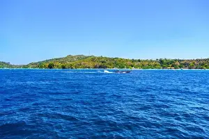 Krabi Prints: Motor ship in the bay of Ko Phi Phi Don Island with huge rocks and cliffs on a sunny day