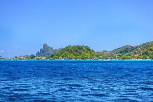 Krabi Prints: Motor ship in the bay of Ko Phi Phi Don Island with huge rocks and cliffs on a sunny day