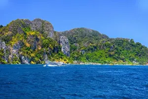 Krabi Prints: Motor ship in the bay of Ko Phi Phi Don Island with huge rocks and cliffs on a sunny day