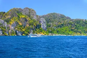 Krabi Prints: Motor ship in the bay of Ko Phi Phi Don Island with huge rocks and cliffs on a sunny day