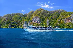 Krabi Prints: Motor ship in the bay of Ko Phi Phi Don Island with huge rocks and cliffs on a sunny day