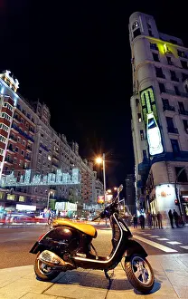 Verticals Prints: Motorbike parked at Gran via street at Christmas time. Madrid. Spain