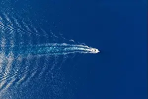 Wake Prints: Motorboat, luxury speed yacht navigating on rippled sea background