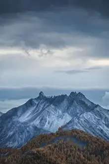 Larch Prints: The mountain Dent Du Ratier in the French Alps during the blue hour after sunset in autumn