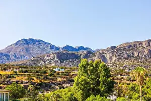 Green Hill Prints: Mountain landscape with rocky cliffs and green trees under bright blue sky in sunny weather