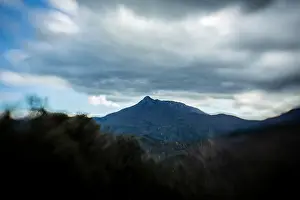 Mountain peak landscape under a stormy cloudscape
