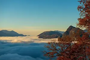 Lugano Prints: Mountain Peak San Salvatore Above Cloudscape with a Autumn Tree and Sunlight with Clear Sky in Lugano