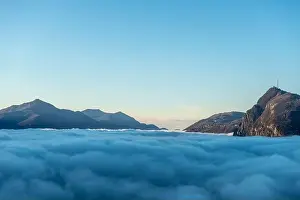 Mountain Peak San Salvatore Above Cloudscape with Sunlight and Clear Sky in Lugano, Ticino in Switzerland