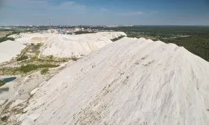 Polluted Prints: Mountain of plant waste on town background aerial drone view