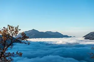 Lugano Prints: Mountain Range Above Cloudscape with Sunlight and Clear Sky in Lugano