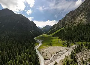 Mountain river and forest in summer Kyrgyzstan. Background with mountain view from drone