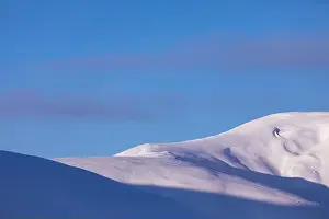 Snow Peak Prints: Mountain winter landscape. Colored dawn over the snow-capped mountains. Drone view