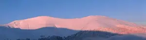 Snow Peak Prints: Mountain winter landscape. Colored dawn over the snow-capped mountains. Drone view