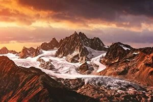 Images Dated 16th October 2018: Mountains peaks sunset landscape. Mountain range with orange light
