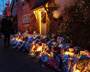 Gathering Prints: Mourners gathering, leaving floral tributes and candles for george michael at his former home in Goring-on-thames